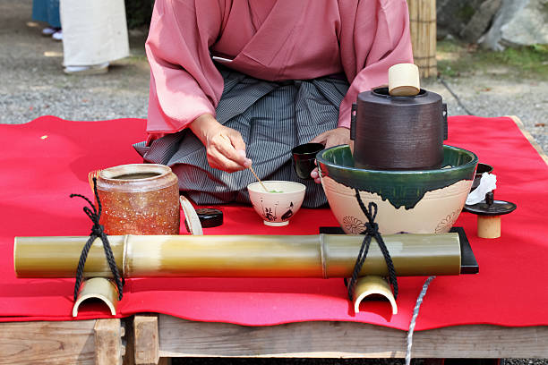 Japanese tea ceremony in garden Kagawa, Japan - September 23th, 2013: Japanese man in traditional kimono prepares the tea ceremony at the japanese garden, which is located in the Hagiwara Temple. . Kung Fu Tea ceremony  stock pictures, royalty-free photos & images